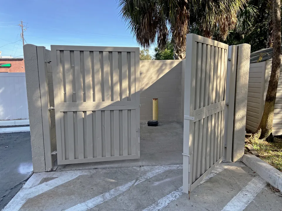 Dumpster enclosure with refinished gates