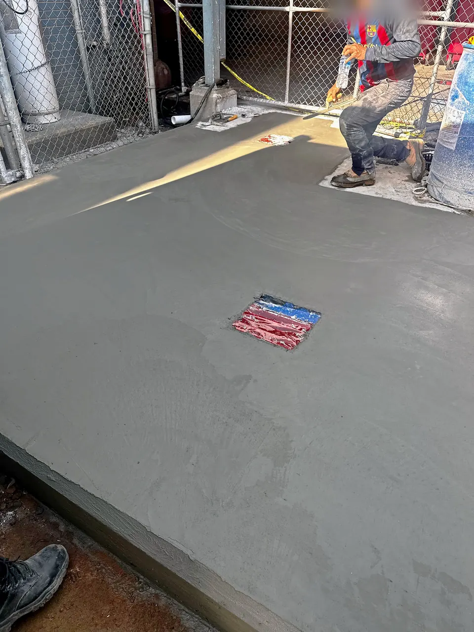 Crew finishing the fresh concrete surface